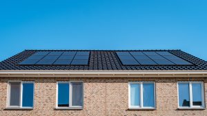 Newly build houses with solar panels attached on roof against a sunny sky Close up of solar pannel